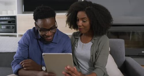 Couple Watching Tablet at Home