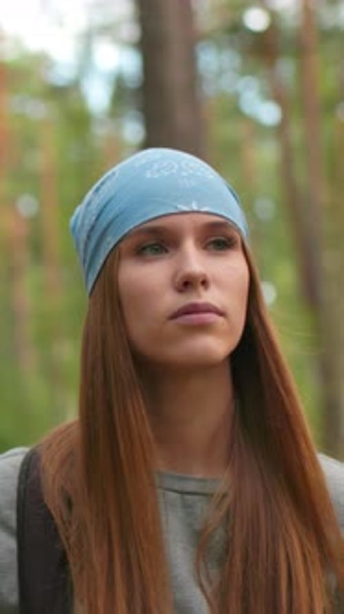 Tired Woman in Bandana Hiking Along Forest Trail with Friend