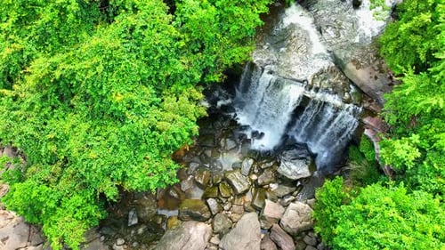 A breathtaking waterfall cascades from a towering cliff.