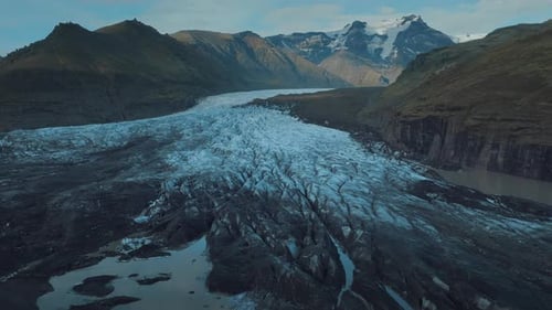 Glacier lagoon in the highlands in Iceland. The icy glacier is rolling down to the lowland.