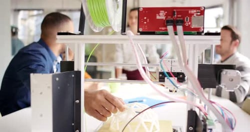 Team Collaborating on 3D Printing Project in Office