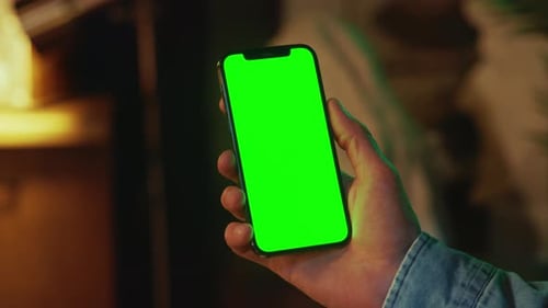 Phone with Vertical Green Screen Hands Using Typing on Smartphone Indoors Social Media Mock Up