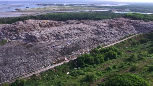 Aerial View of Big Garbage Dump Surrounded By Greenery Environmental Pollution