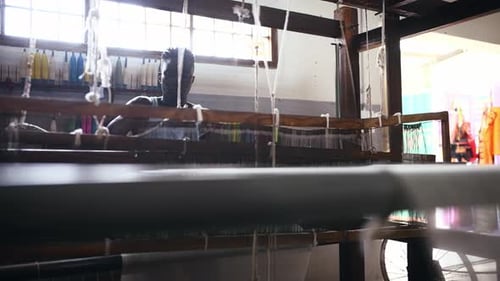 Loom, weave and man with textile, fabric and material for production in workshop for clothing