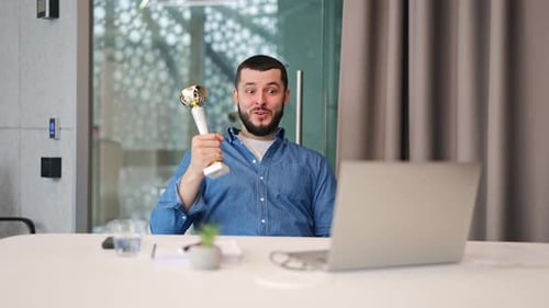 Happy Professional Celebrates Success With Golden Trophy