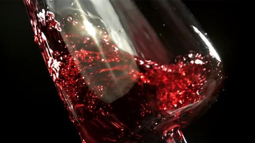 Red Wine Poured into Elegant Glass Close Up