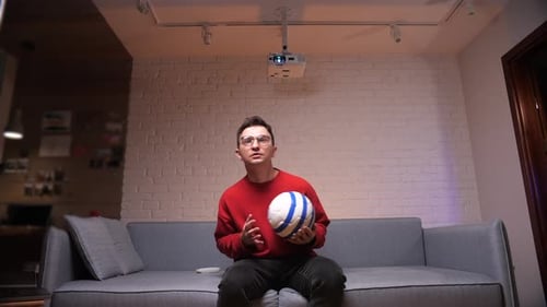Man Watching Sports with Projector at Home