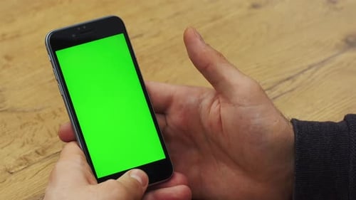 Man Using Vertical Smartphone with Green Screen Closeup Shot of Man's Hands with Mobile Phone Chroma