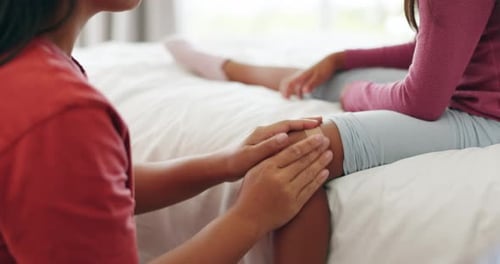 Adult Applying Bandage to a Girl's Knee