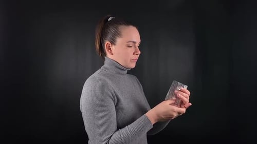 Woman Takes Pill from Blister Pack