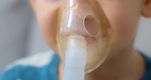 Child Using Nebulizer Mask for Respiratory Treatment