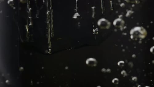 Water Bubbles with Ice Cubes in Dark