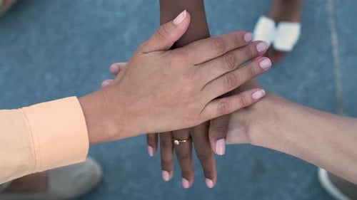 Top View of Young Multiracial People Putting Their Hands Together
