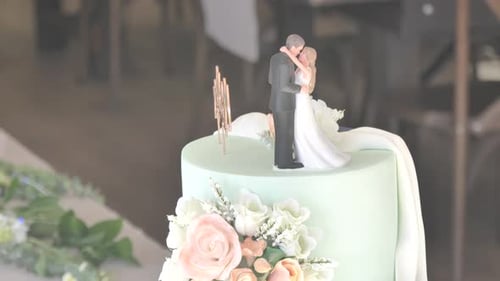 Elegant Wedding Cake Topped with Loving Bride and Groom