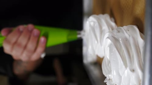 Confectioner Making Pavlova Cakes Squeezes Meringue Out of Pastry Envelope Vertical Footage Piping
