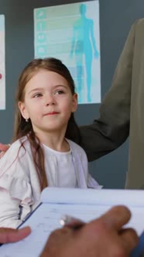 Cheerful Little Caucasian Girl Having Medical Checkup at Pediatric Clinic