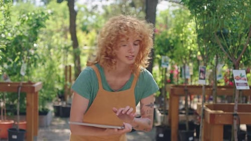 Gardener Using Digital Tablet in Plant Nursery Slow Motion