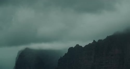 Cloudy Dark Gray Sky in Bad Weather Day Rainy Stormy Cloudscape Over High Tops of Rocks Serene View