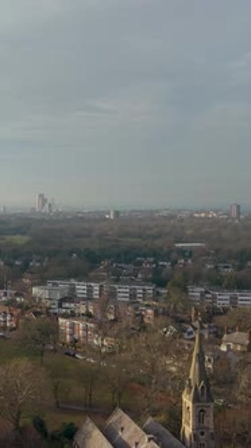 Vertical drone rise and camera tilt over Christchurch Green, Wanstead, London