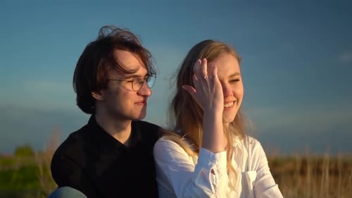 Smiling Couple Enjoying Sunset Together Outdoors