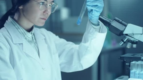 Young Woman Analyzing Sample in Lab