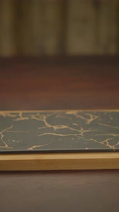 An Elegant Black and Gold Marble Tabletop That Enhances Any Space with Its Chic Design
