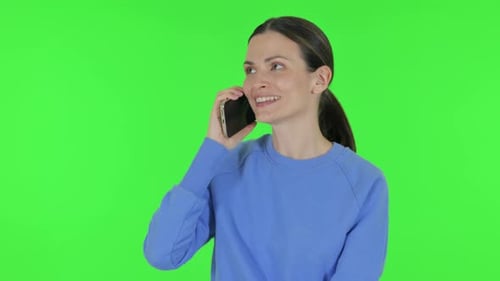 Woman Talking on phone on Green Background