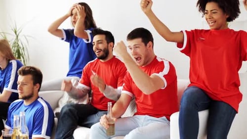 Enthusiastic friends watch sports in the living room