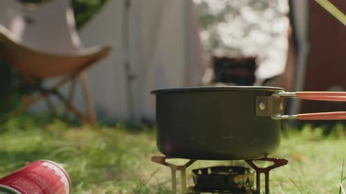 Camping Pot Boiling on Gas Burner Outdoors