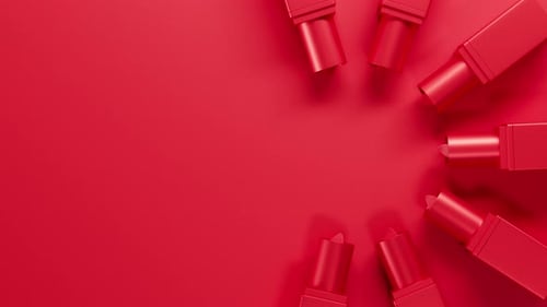 Top View on Red Lipstick Set Twists Up From Red Tubes on Red Backdrop Lipstick Group Extend