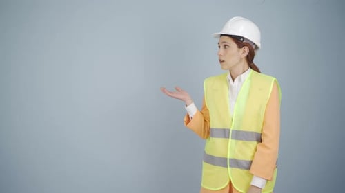 Engineer looking at camera in amazement and making a presentation.