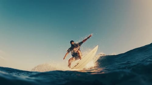 Surfer Rides the Ocean Wave in the Maldives In Water and Underwater View of the Surfer on the Wave