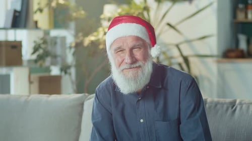Smiling Senior Man Wearing a Christmas Santa Hat