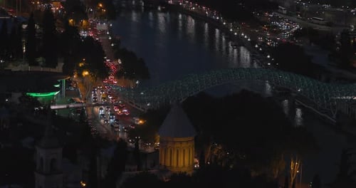 Tbilisi Georgia Night View Of Bridge Of Peace Over Kura Mtkvari River In Evening Illuminations