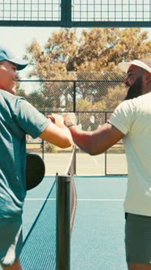 Two Men Bump Fists Before Game on Blue Court