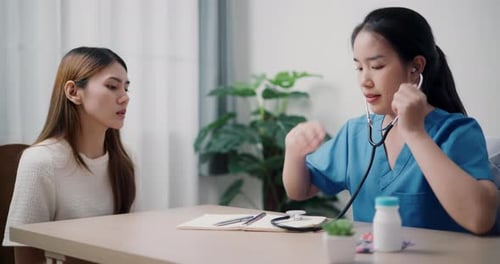 Healthcare Professional Listens to Patient with Stethoscope