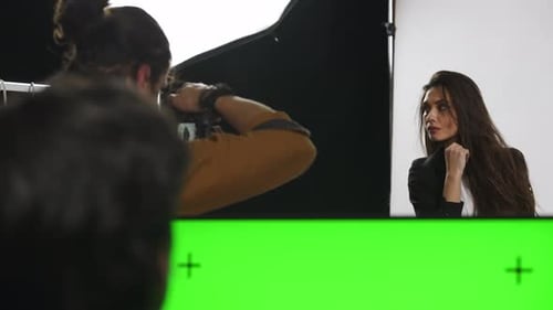 Model and Production Team in the Studio Attractive Woman Posing in Suit Editor Checking Pictures on