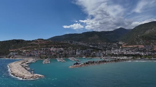 Touristic seaside coastal city, drone view of shore where ships stop