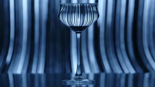 Clear Wine Glass Standing Infront of a Fast Falling Rain Like Pattern in the Background