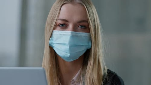 Portrait Caucasian Business Woman in Face Medical Protective Mask in Office with Laptop Working
