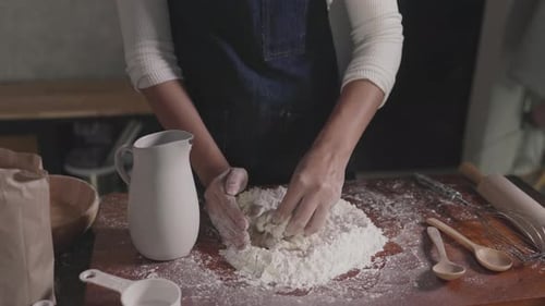 Woman Kneading Dough on Kitchen Countertop
