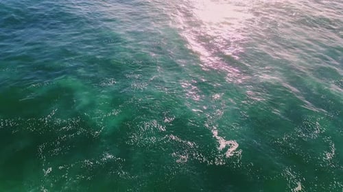 Calm Waves Reflecting Sun in Morning Closeup. Tranquil Sunlight Water Moving Slowly Waving. Beaut...