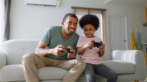 Father and Son Playing Video Games at Home