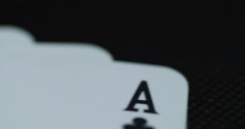 A close up macro shot of playing cards with all four aces hearths diamonds space cross lying on an e