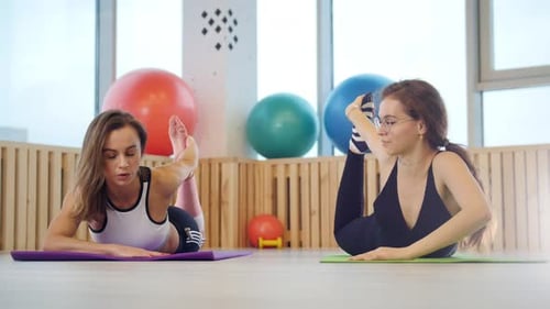 Young Women Doing Fitness in the Studio Training Their Leg