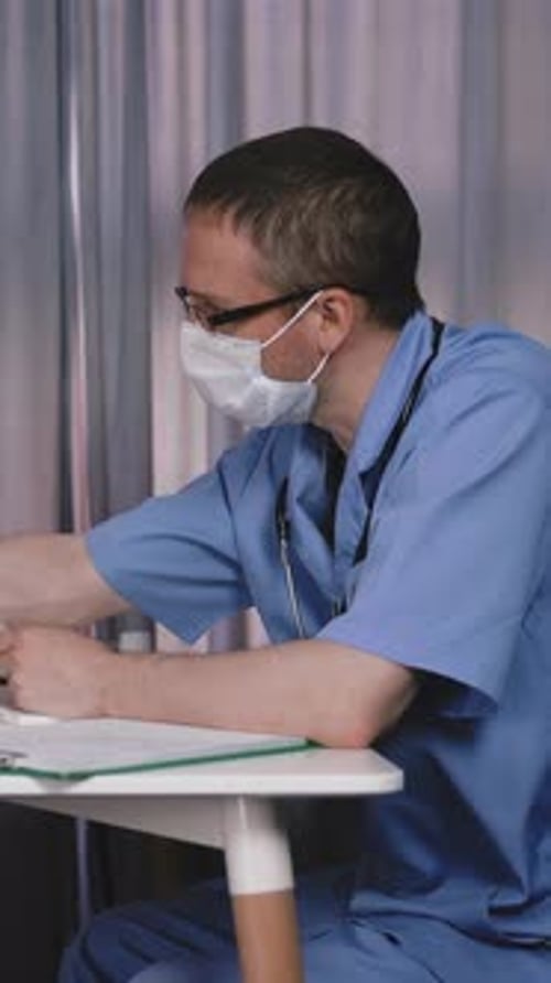 Doctor examines child wearing mask in the clinic