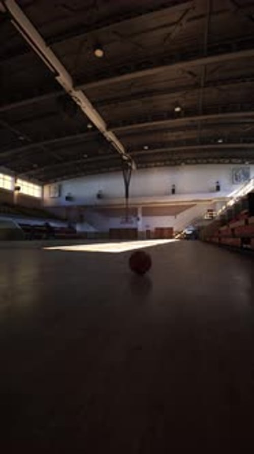Basketball in Center of Empty College Gym