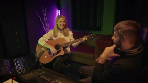 Talented Female Musician Playing Guitar for Sound Producer in Recording Studio Audition and Casting