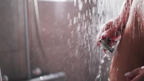 Woman Shaves Leg in Shower Close Up