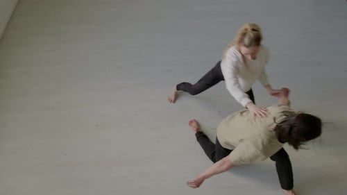 Duo Dancing and Practicing Acrobatics in Bright Studio
